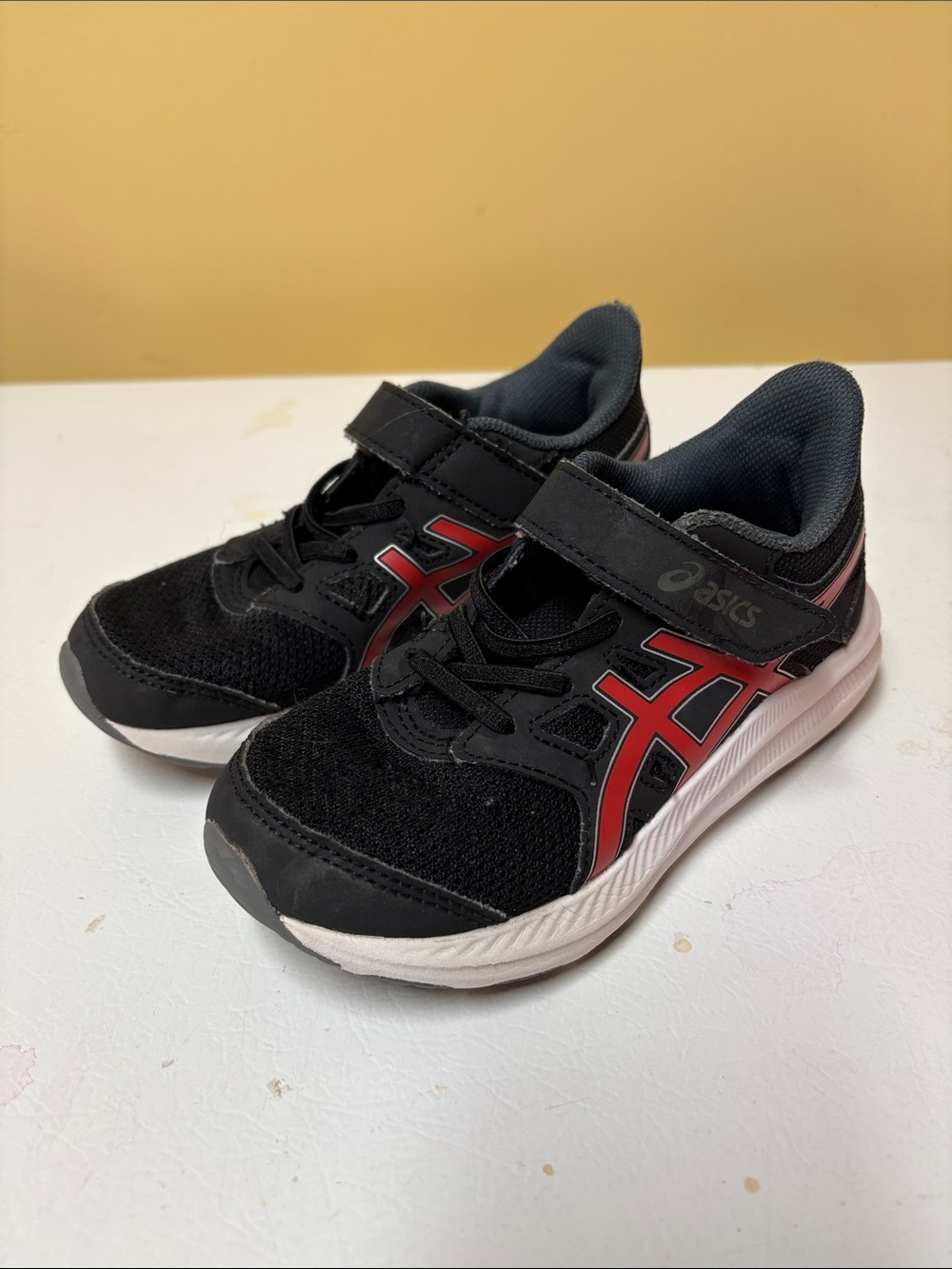 ASICS Kids Black Sneakers with Red Accents